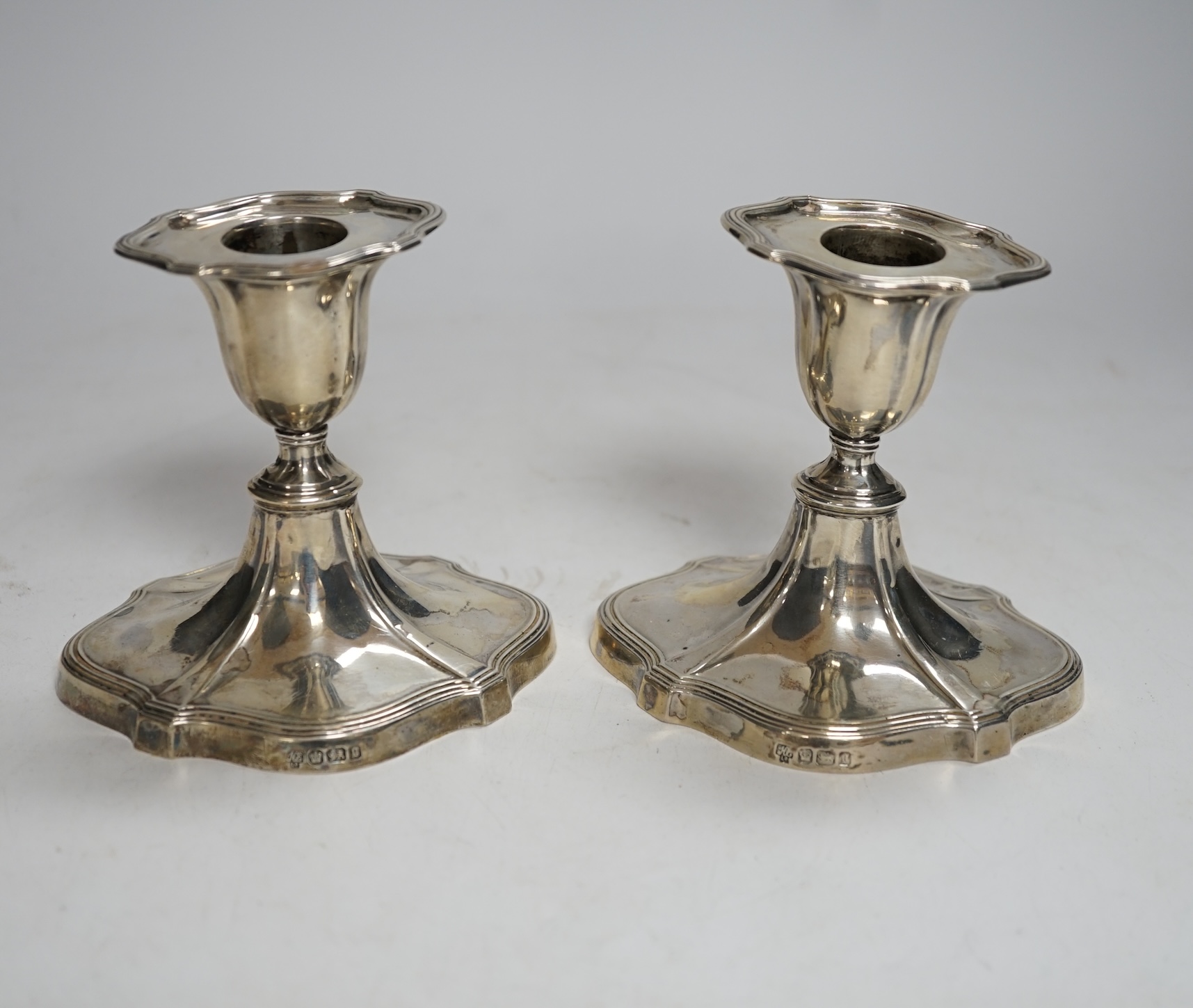 A pair of late Victorian silver mounted dwarf candlesticks, Hawksworth, Eyre & Co, Sheffield, 1899, 93mm.